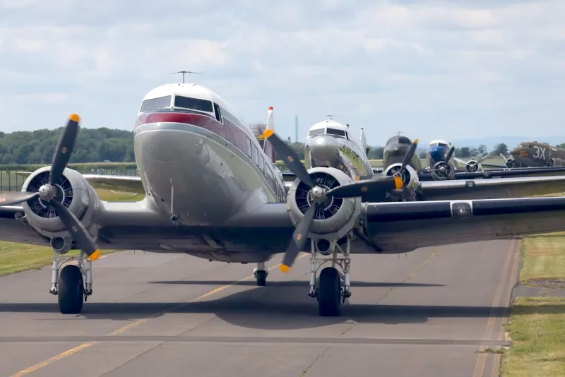 Restored Douglas DC-3 warbirds taxiing at a Veterans Day fly-in
