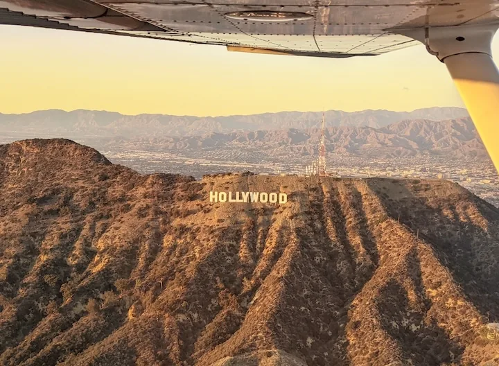 The Hollywood Sign on Mount Lee at golden hour, from a Cessna during a discovery flight